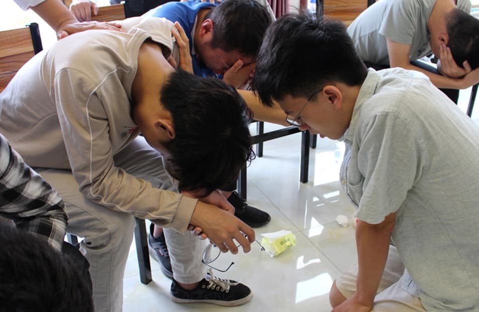 Students bowed together in prayer