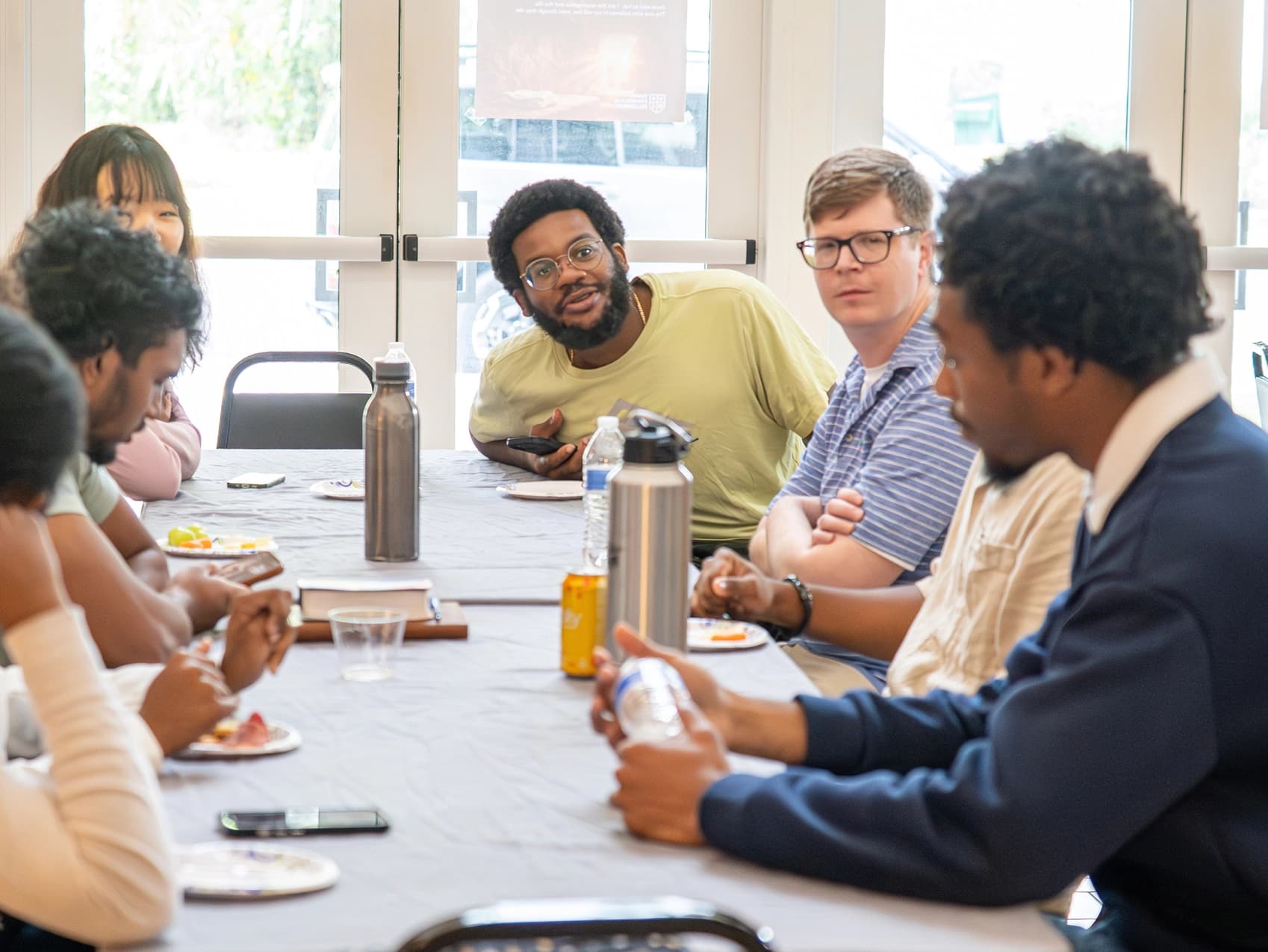 Students gathered around a table for Bible study