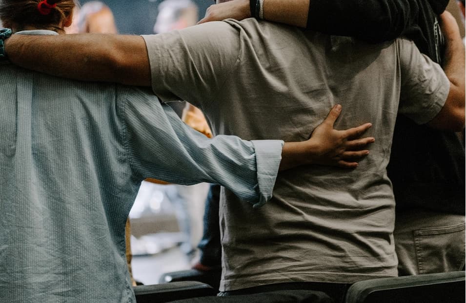 Believers embracing one another in fellowship