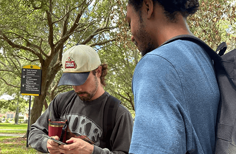 Team members talking on a university campus