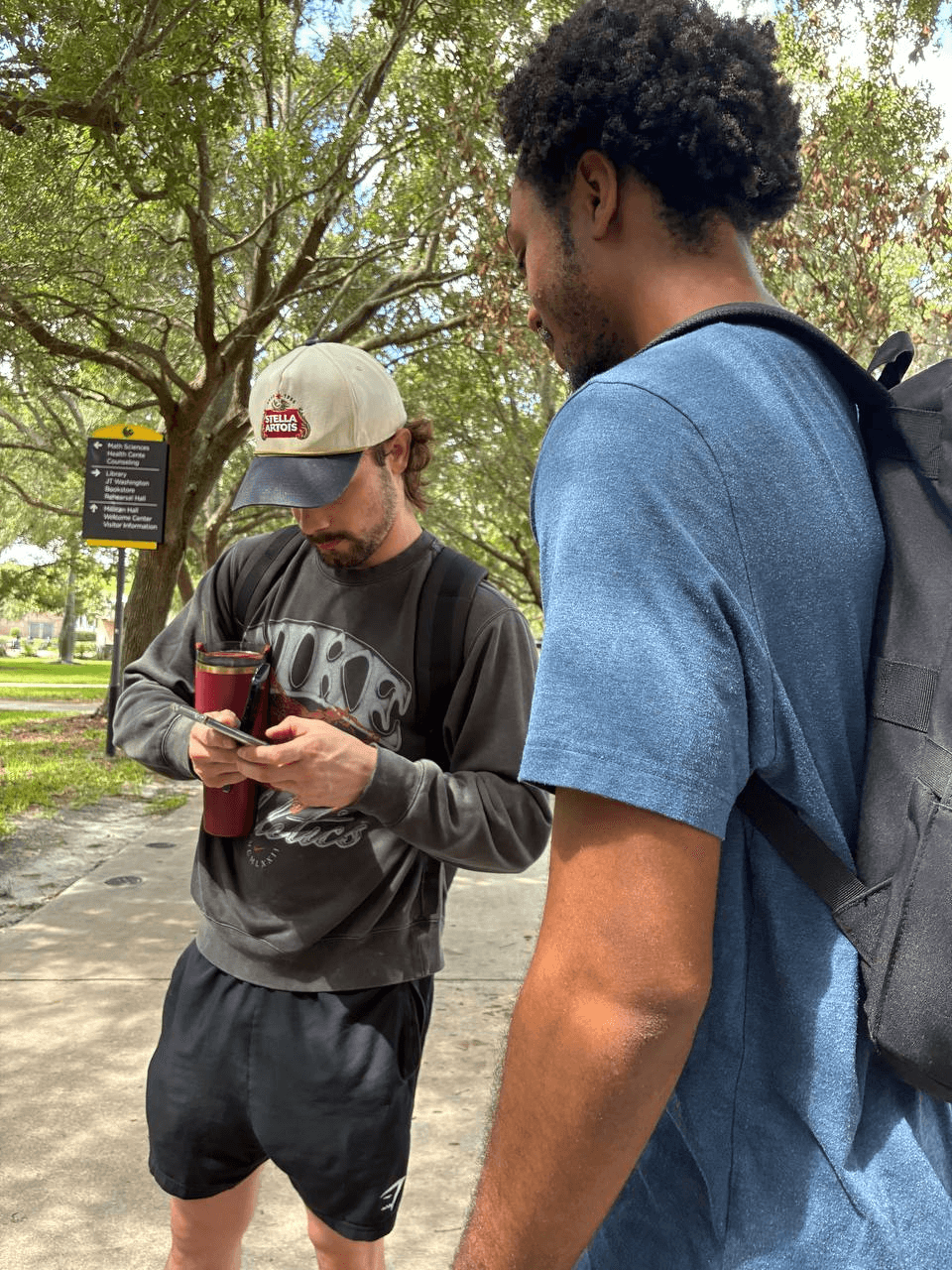 Two students talking on a campus path