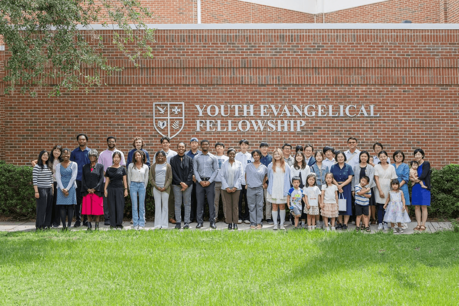 The YEF fellowship gathered outside the headquarters sign