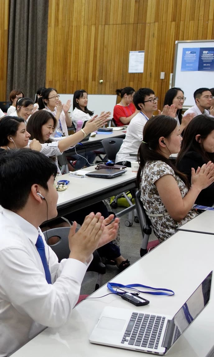 YEF students clapping at a leadership training conference