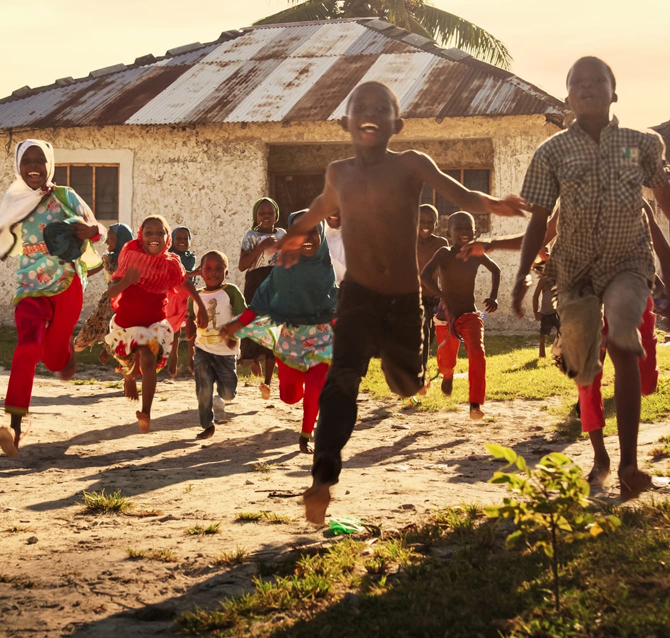 Children running joyfully to greet a mission team