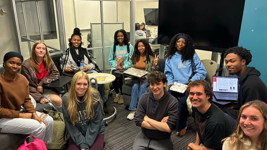 A campus fellowship group gathered in a study lounge