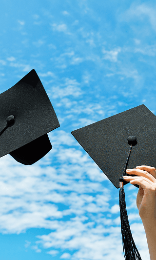 Graduation caps thrown in the air