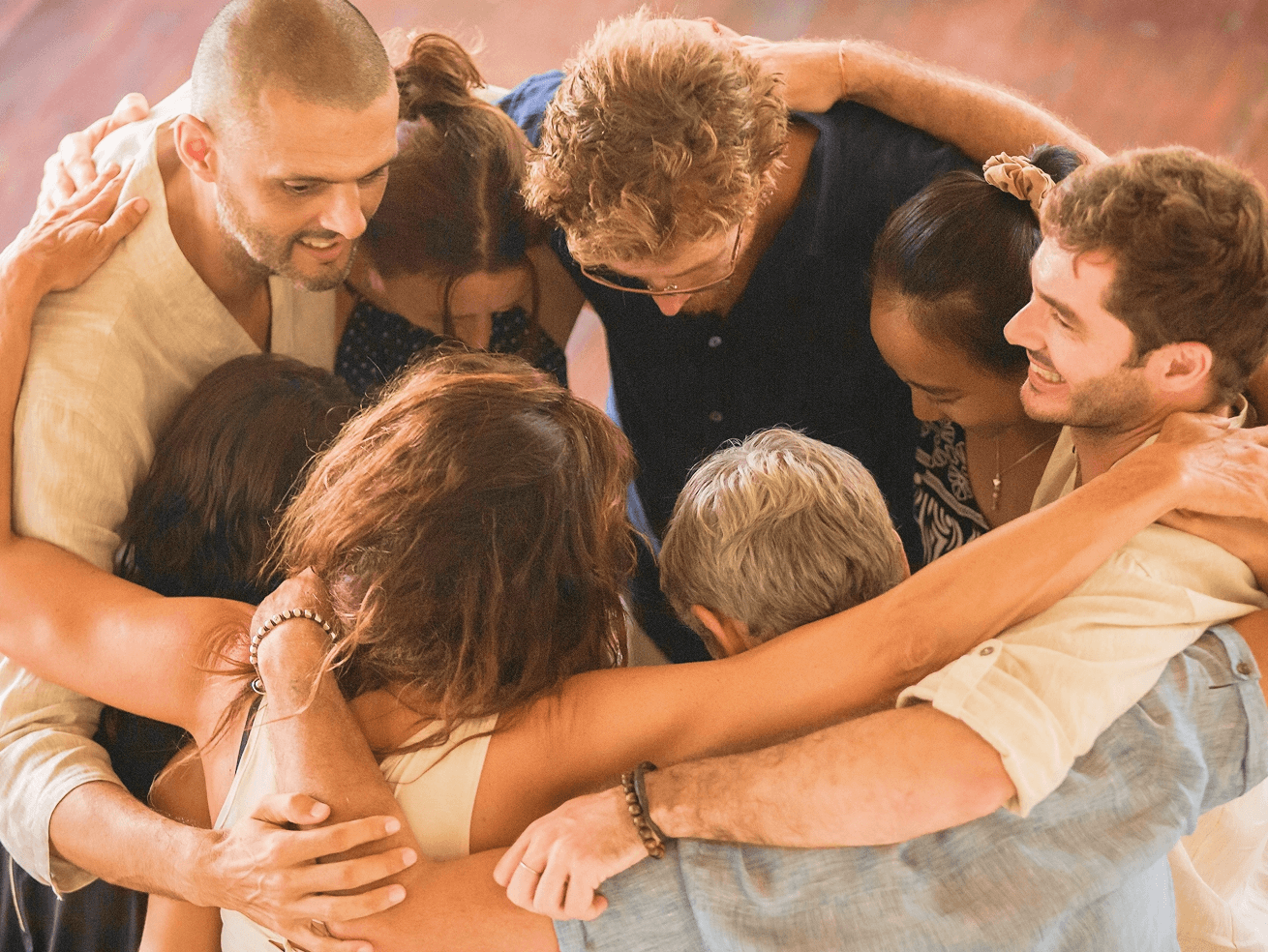 A circle of YEF members with their arms around one another in prayer