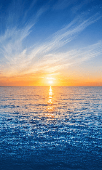 The sun setting over the ocean